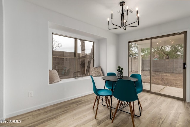 10625 E Bramble Ave, Mesa, AZ 85208 - dining space with a chandelier, light wood-style floors, and baseboards