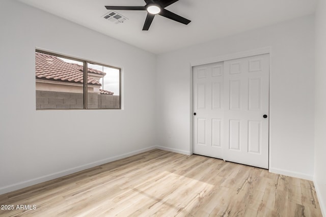 10625 E Bramble Ave, Mesa, AZ 85208 - unfurnished bedroom featuring wood finished floors, a closet, and baseboards