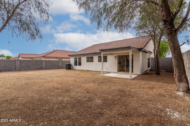 10625 E Bramble Ave, Mesa, AZ 85208 - rear view of house with a tile roof, a fenced backyard, central AC, stucco siding, and a patio