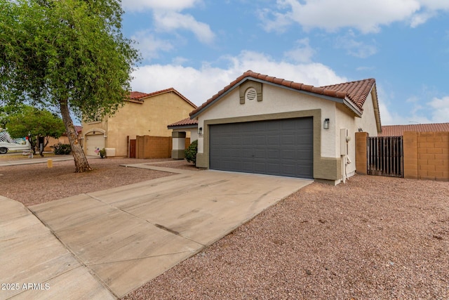 10625 E Bramble Ave, Mesa, AZ 85208 - mediterranean / spanish house with stucco siding, a gate, driveway, and a garage
