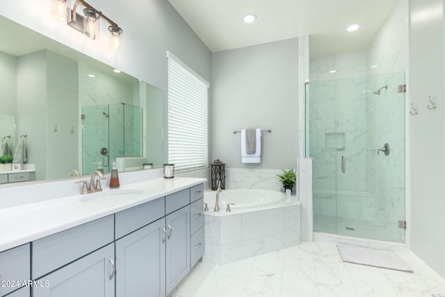 bathroom featuring shower with separate bathtub and vanity