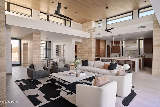 tiled living room featuring a high ceiling, wood ceiling, and ceiling fan