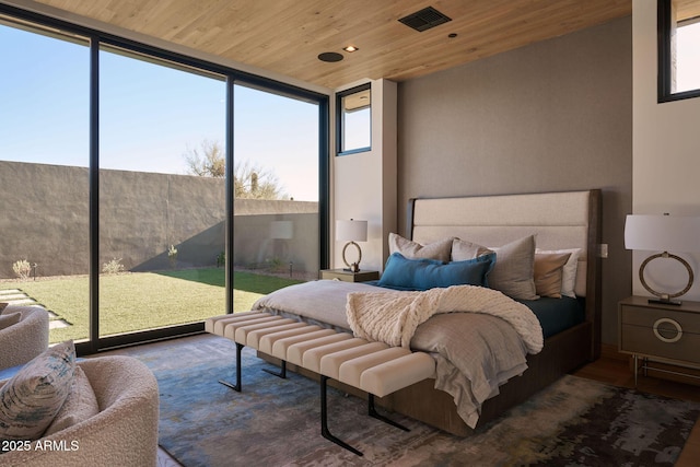 bedroom with hardwood / wood-style floors, a wall of windows, access to outside, and wooden ceiling