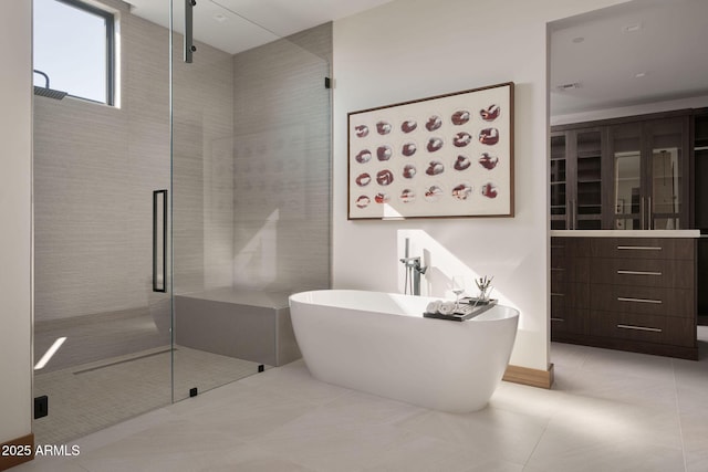 bathroom with tile patterned flooring and plus walk in shower