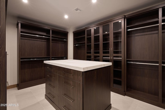 spacious closet with light tile patterned floors