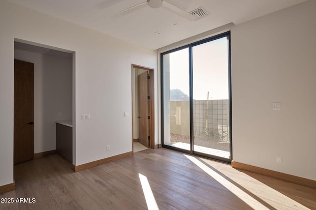 unfurnished room featuring ceiling fan and light hardwood / wood-style floors