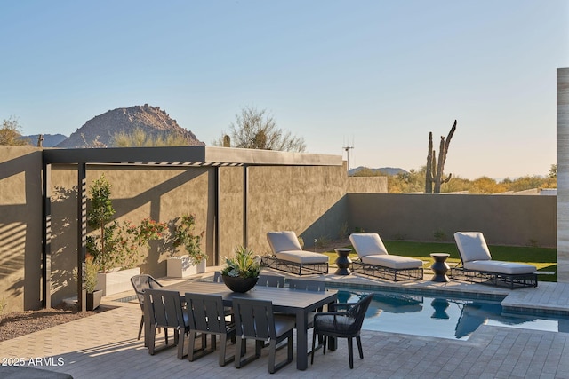 view of swimming pool with a mountain view