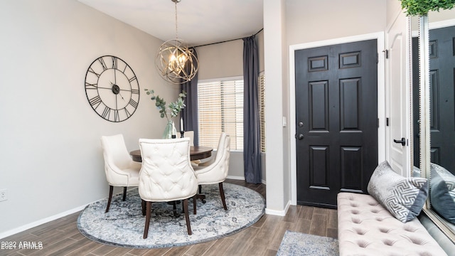 dining room with dark wood-type flooring and a notable chandelier