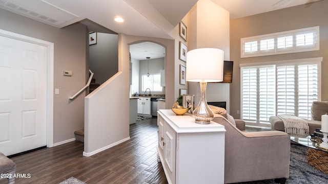 living room featuring dark hardwood / wood-style floors and a healthy amount of sunlight