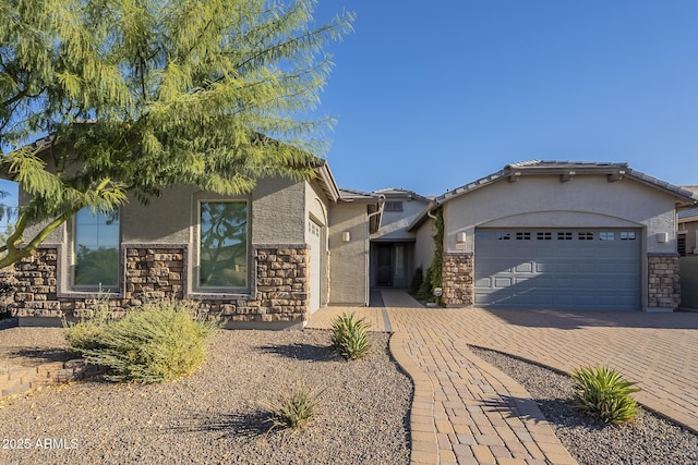 28917 N 66th Ave, Phoenix, AZ 85083 - view of front of house with a garage, stucco siding, decorative driveway, and stone siding