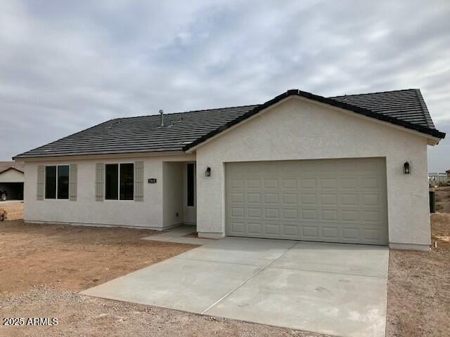 22343 S Manzanilla Rd, Buckeye, AZ 85326 - single story home featuring a garage, stucco siding, and concrete driveway