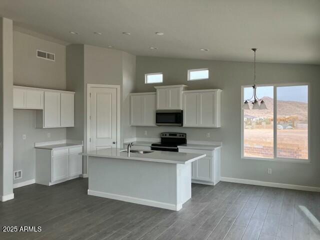 22343 S Manzanilla Rd, Buckeye, AZ 85326 - kitchen with stainless steel microwave, black / electric stove, white cabinetry, dark wood-type flooring, and high vaulted ceiling