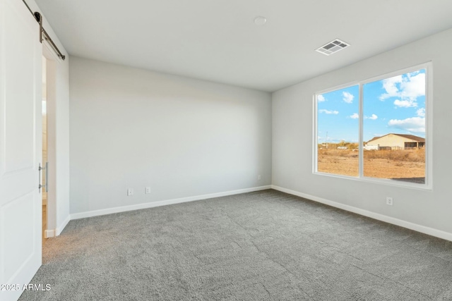 22343 S Manzanilla Rd, Buckeye, AZ 85326 - spare room featuring a barn door and carpet floors
