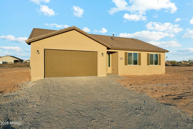 22343 S Manzanilla Rd, Buckeye, AZ 85326 - single story home featuring dirt driveway, a garage, and stucco siding