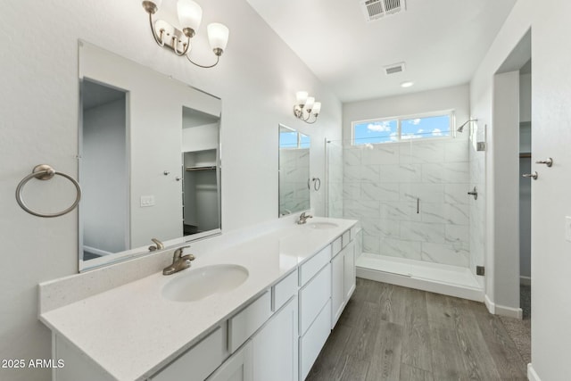 22343 S Manzanilla Rd, Buckeye, AZ 85326 - full bathroom with double vanity, wood finished floors, and a stall shower