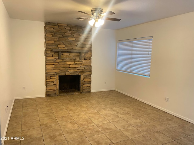 unfurnished living room with a fireplace, tile patterned flooring, and ceiling fan