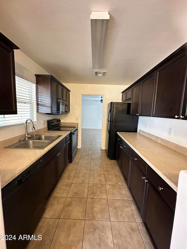 kitchen featuring light tile patterned flooring, black appliances, dark brown cabinets, ceiling fan, and sink