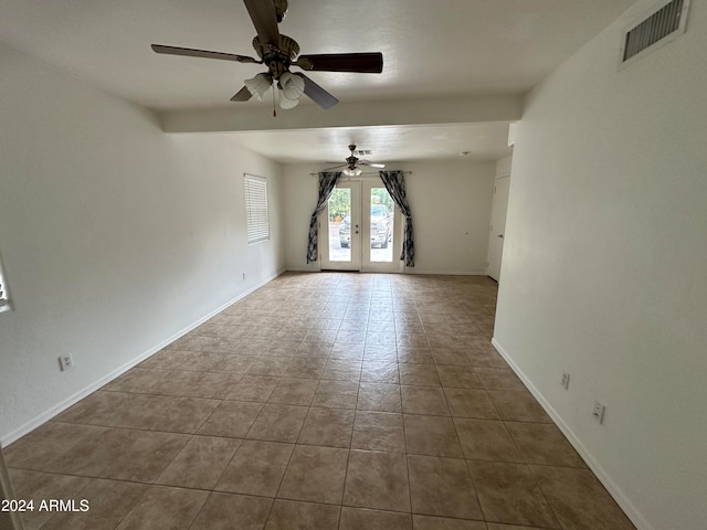 tiled spare room with ceiling fan and french doors