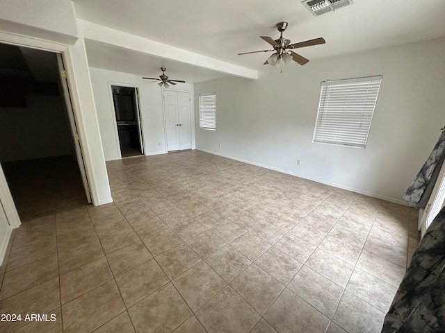 interior space with ceiling fan and light tile patterned floors