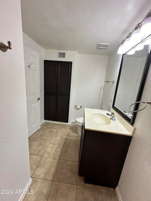 bathroom featuring tile patterned floors, toilet, and vanity