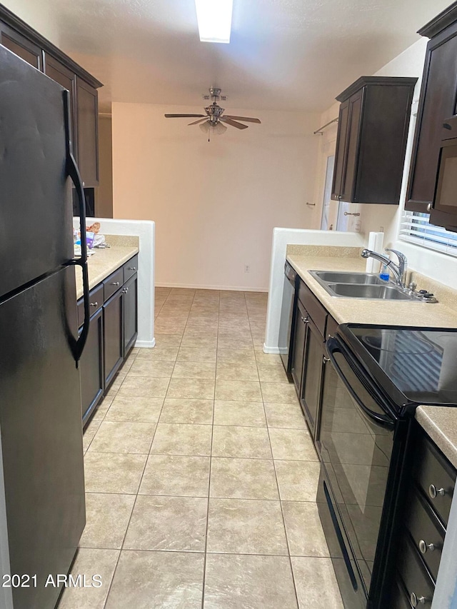 kitchen featuring light tile patterned flooring, black appliances, sink, and ceiling fan