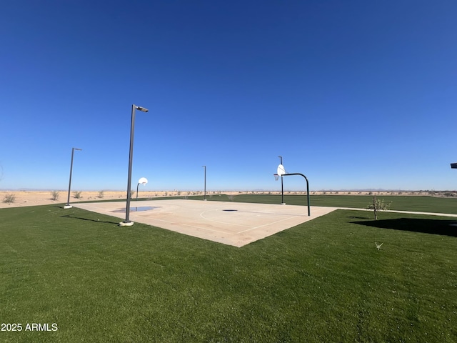 view of basketball court with a lawn