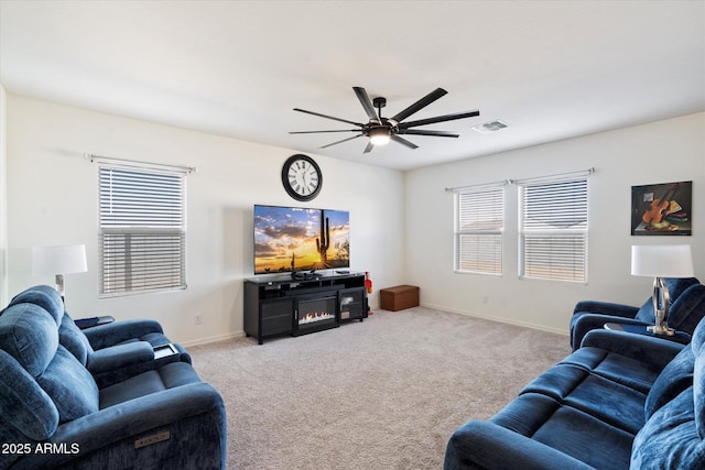 carpeted living room with ceiling fan