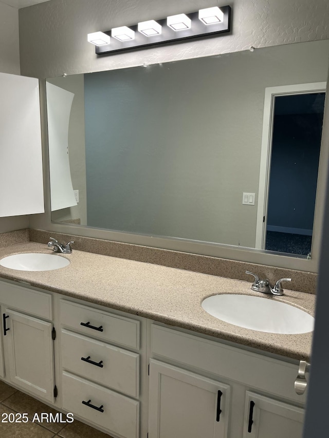 bathroom featuring double vanity, tile patterned floors, and a sink