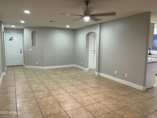 empty room with baseboards, recessed lighting, visible vents, and a sink