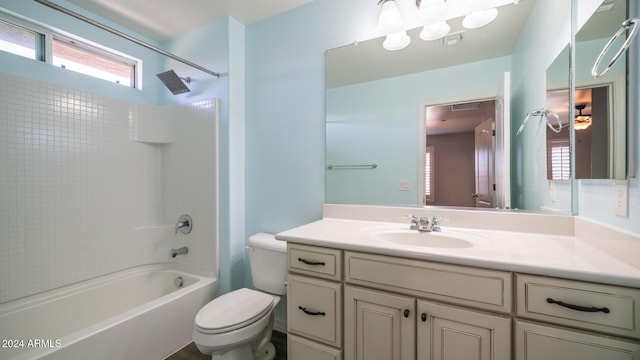 full bathroom with shower / tub combination, ceiling fan, vanity, and toilet