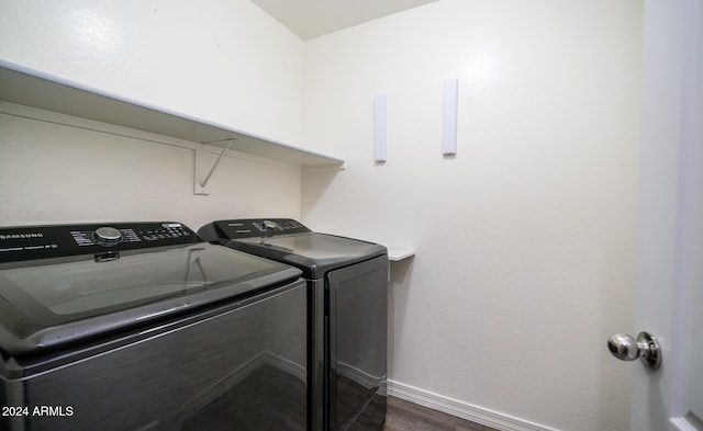 laundry area featuring washer and clothes dryer and dark hardwood / wood-style floors