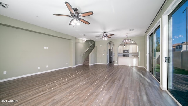 unfurnished living room with ceiling fan and wood-type flooring