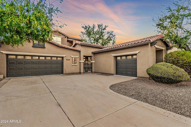 mediterranean / spanish home featuring a garage