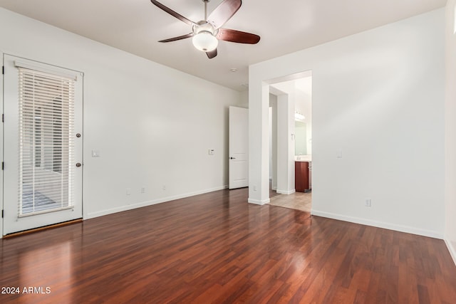 empty room featuring ceiling fan and dark hardwood / wood-style flooring