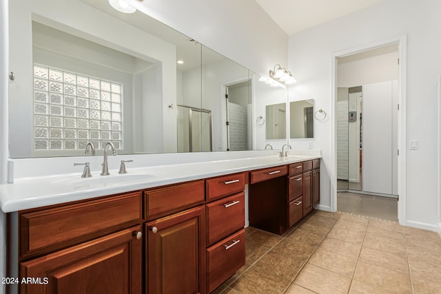 bathroom with vanity, a shower with shower door, and tile patterned floors