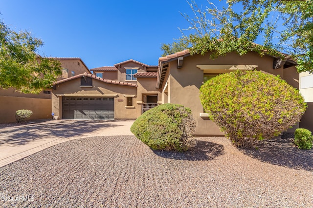 mediterranean / spanish house featuring a garage