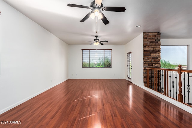 unfurnished living room featuring a healthy amount of sunlight, hardwood / wood-style flooring, and ceiling fan