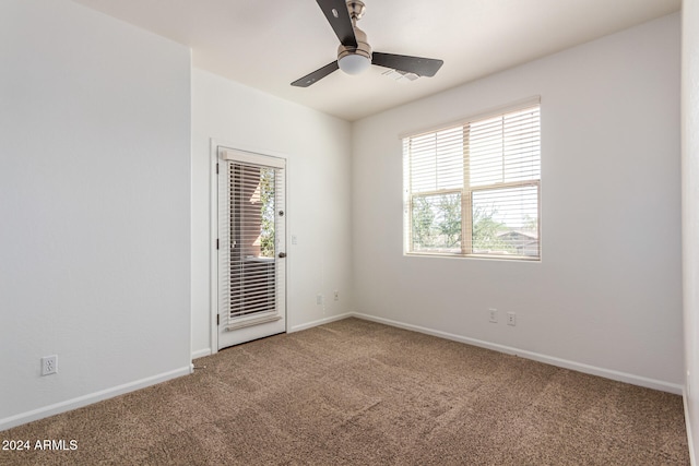 spare room featuring carpet flooring and ceiling fan