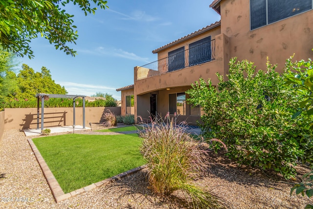 view of yard with a patio and a balcony