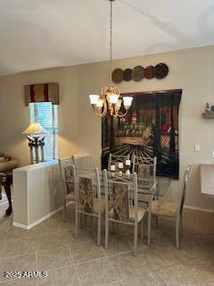 dining room with baseboards and an inviting chandelier