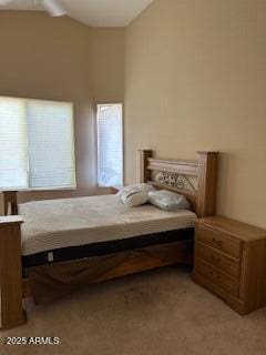 bedroom with light carpet and vaulted ceiling