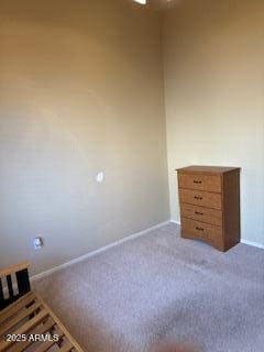 unfurnished bedroom featuring carpet floors and baseboards