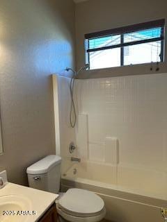 bathroom with vanity, toilet, and shower / tub combination