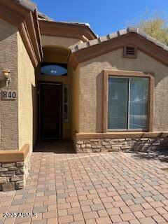 property entrance with stucco siding