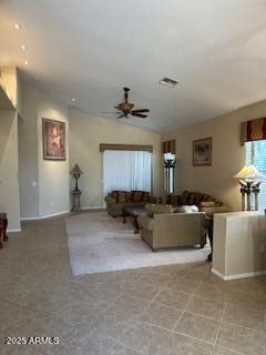 living room featuring baseboards, ceiling fan, and lofted ceiling
