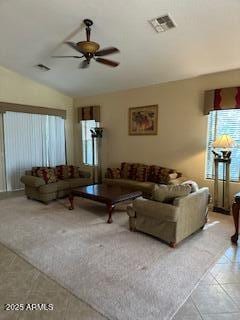 living area with tile patterned flooring, ceiling fan, visible vents, and lofted ceiling