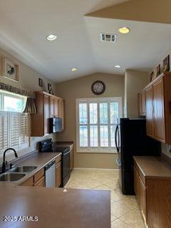 kitchen with a sink, dishwasher, range with electric cooktop, light tile patterned floors, and lofted ceiling