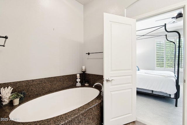 bathroom featuring connected bathroom and a bath