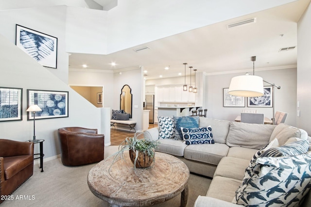 living room featuring crown molding, recessed lighting, light colored carpet, and baseboards