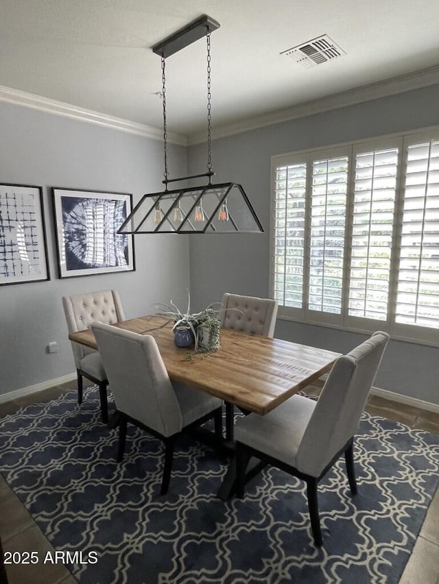 dining area featuring healthy amount of natural light, baseboards, and ornamental molding